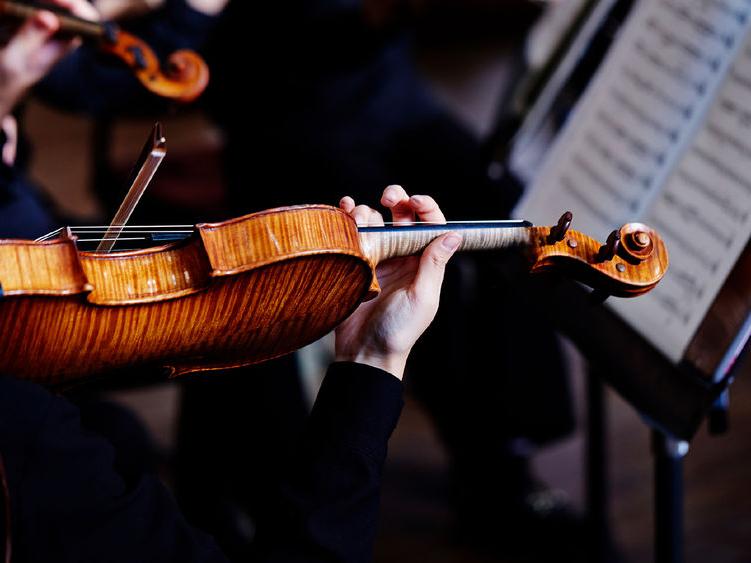 a violinist playing in an orchestra